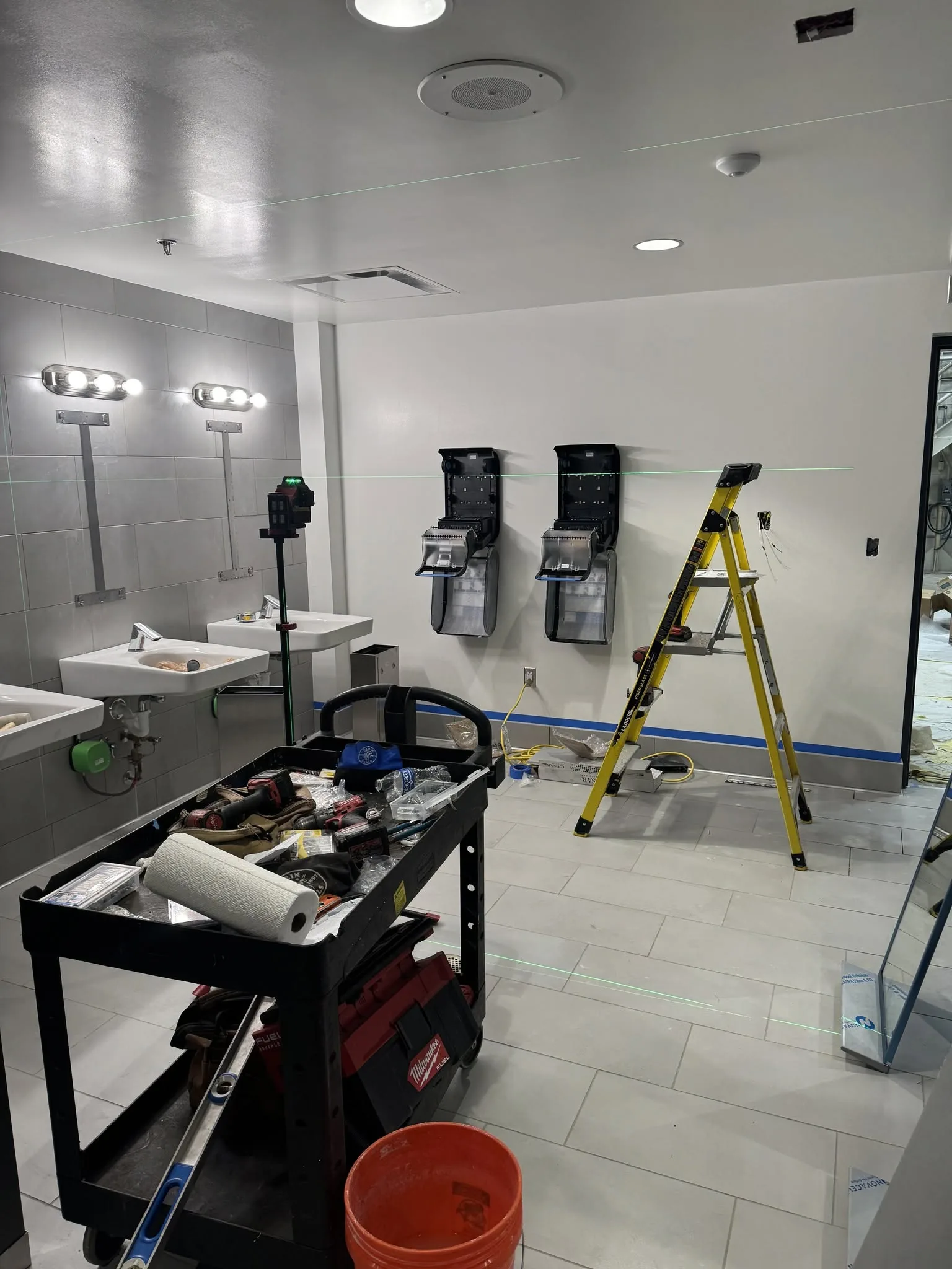 Commercial restroom vanity and sink area partially completed.