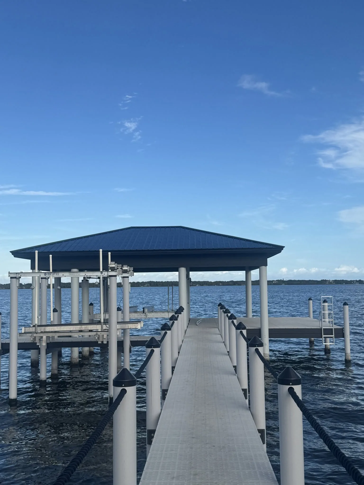 Finished dock structure extending over calm water.