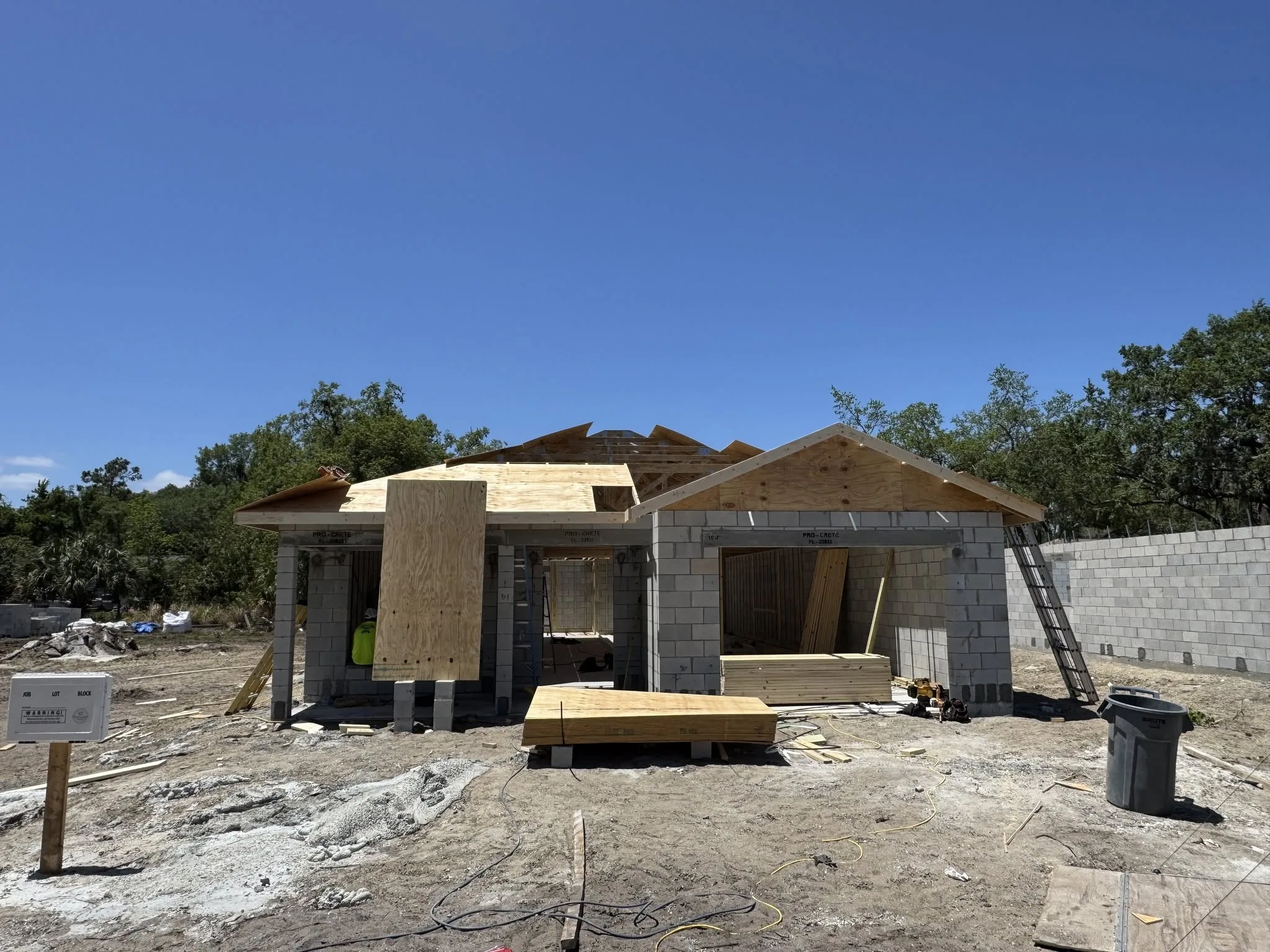 Commercial building exterior during active renovation with new framing visible.