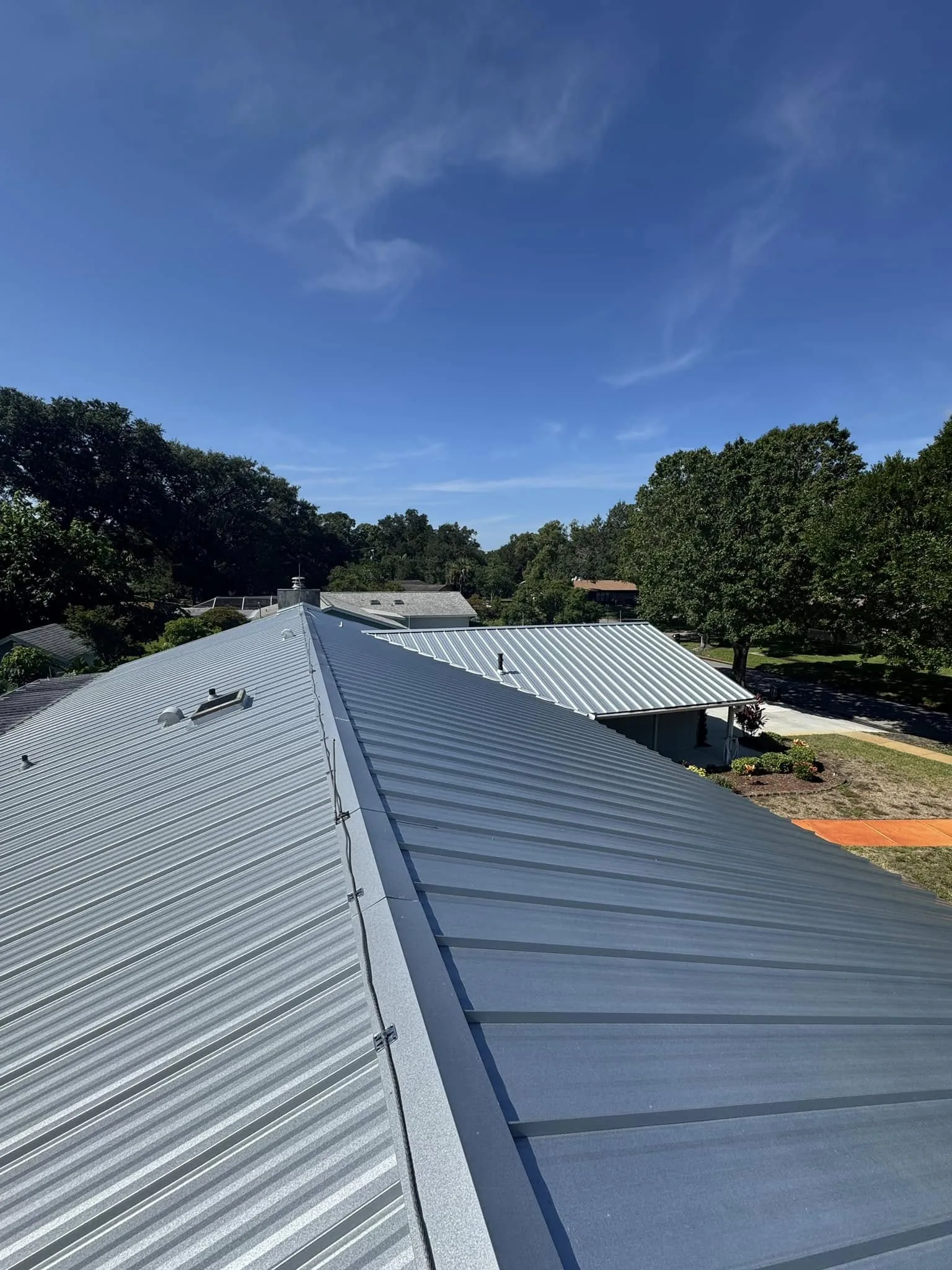 Completed metal roof installation on a residential building.