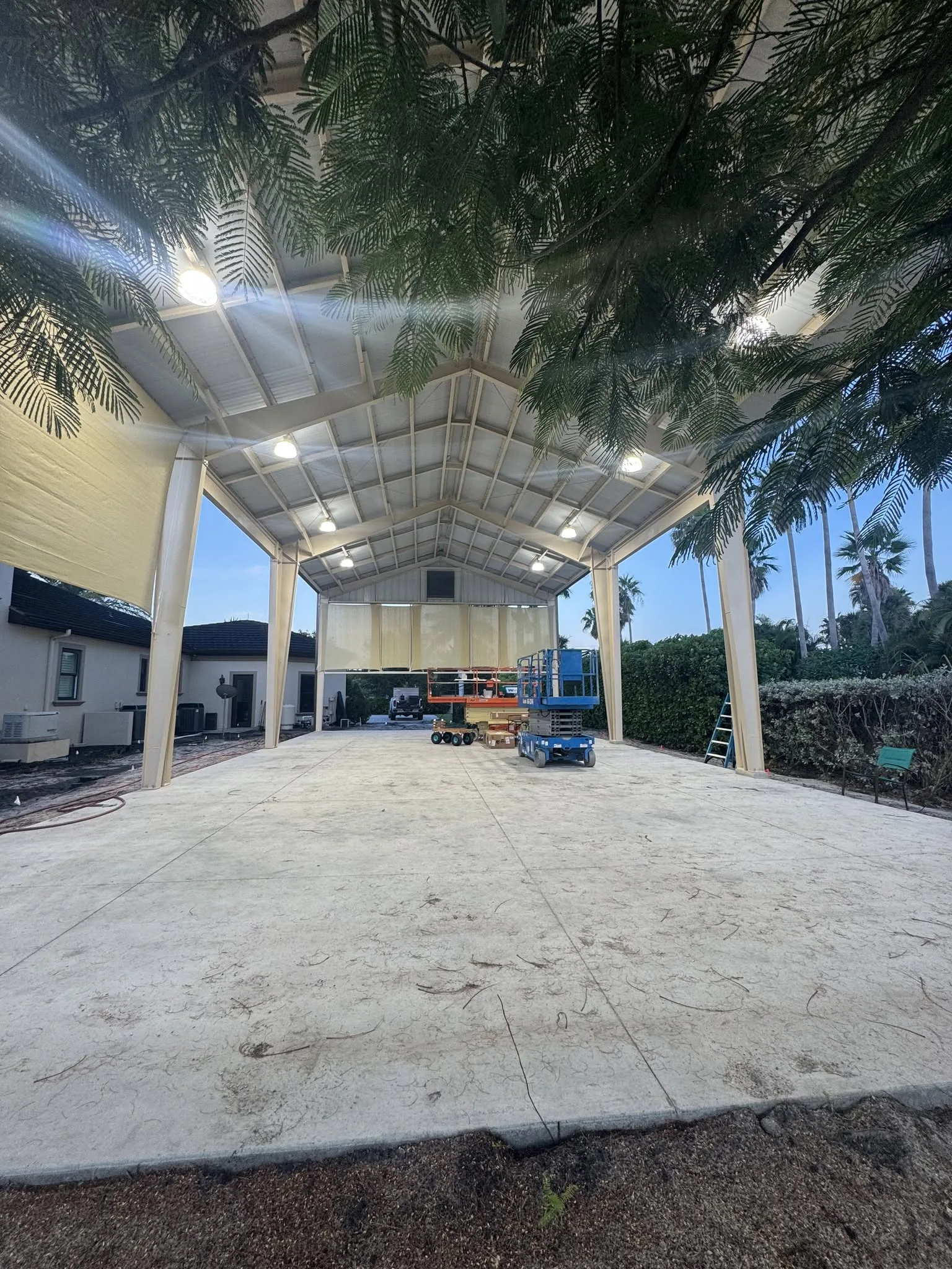 Open-air covered pavilion structure during site preparation work.