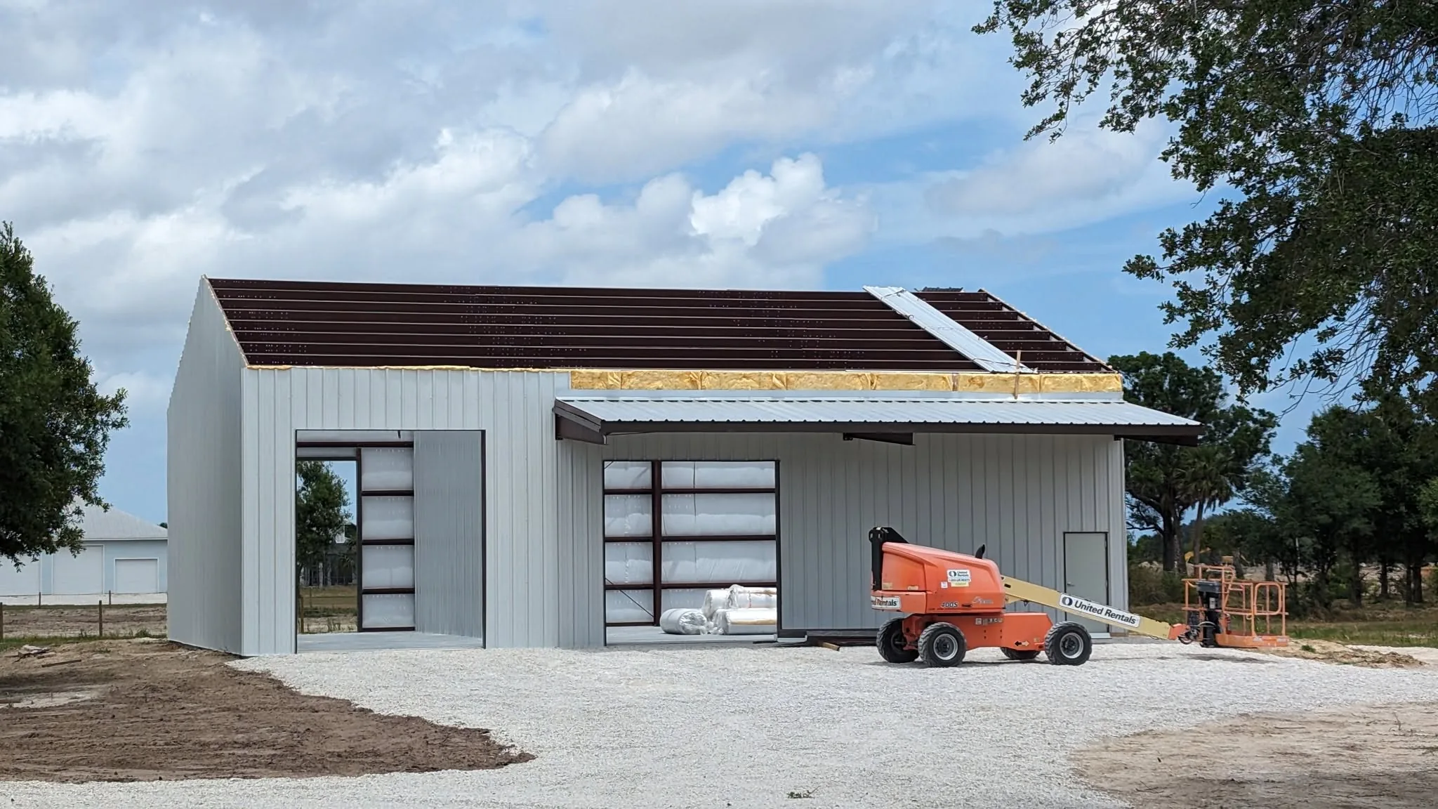 Completed commercial steel building with roll-up door and site work in Brevard County.