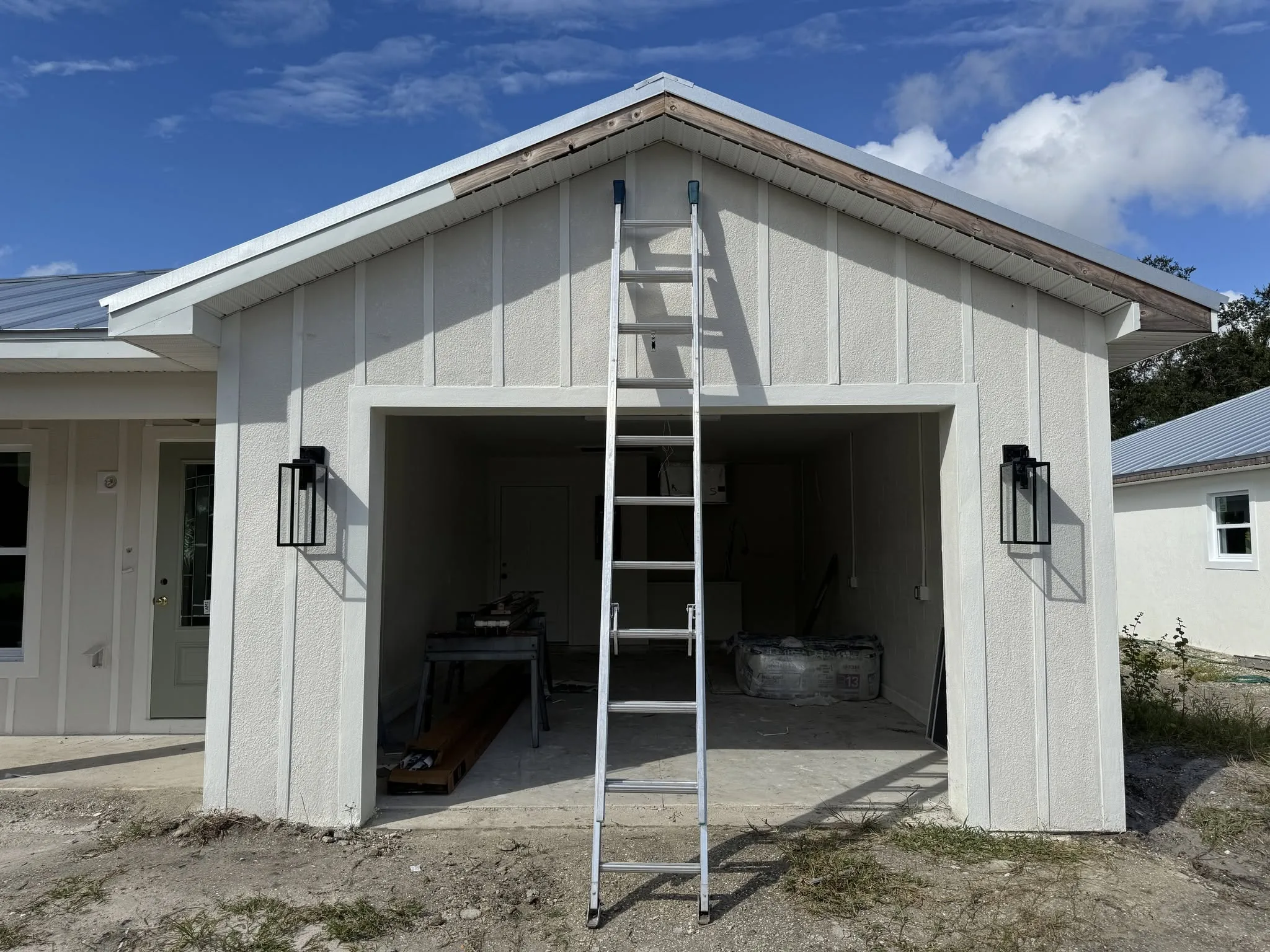 Completed commercial steel building with metal panel siding and roll-up bay doors.