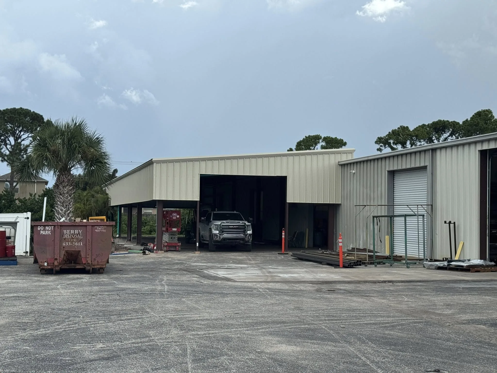 Large commercial steel building with multiple bay doors.