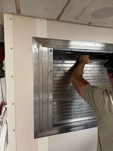 Roll-up door being installed on a commercial steel building.